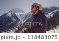 Advanced male skier in goggles and helmet holds ski poles preparing for exciting skiing session 118483075