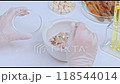 Scientist scoops powder from cloves and poria cocos wolf just crushed into a petri dish for experiment. Sample video of lab experiment with high angle 118544014