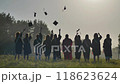 Graduates are celebrating throwing their graduation caps in the air 118623624