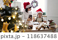 Mother and daughter baking cookies together at Christmas time 118637488