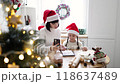 Mother and daughter baking cookies in festive kitchen for Christmas 118637489