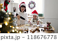 Mother and daughter baking cookies together for Christmas 118676778