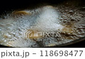 Water boils in a saucepan. Ravioli boiling in water. Boiling water foams. Dumplings are cooked in sauce. Hot water bubbles on the fire in the kitchen. Delicious food is being prepared. Cook food 118698477