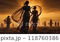 Women in flowing dresses walking together at sunset on a serene landscape with ethereal lighting and silhouettes 118760386