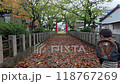 Child running through autumn leaves 118767269