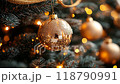 Close-up of a golden Christmas ornament hanging on a decorated tree 118790991