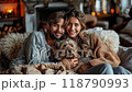 A family with a dog smiling and relaxing in a warm and cozy home 118790993