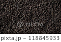 Background of black fanning or broken loose leaf tea slowly rotating. Close up, top view 118845933