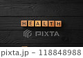 Wooden cubes with letters and the word Wealth move and change to the Health on a black background. Concept of Investment, Insurance and Health Care. Stop motion, looped video.. High quality 4k footage 118848988