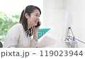 A woman talking on a smartphone with documents in her hands 119023944
