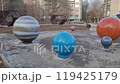City of Yasny, Russia - October 19, 2024 Street art objects about the Solar system. Model of the sun and the earth in the open air of the scientific site Cosmodrome of Childhood. Editorial 119425179