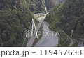 Aerial around epic modern cable-stayed bridge Adler road Krasnaya polyana Sochi Russia suburban freeway cars traffic among high mountains. Natural landscape green slopes. Travel landmark. High quality 119457633