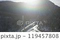 Aerial of a highway in the mountains. An automobile cable-stayed bridge over a mountain river in a gorge. The concept of civil engineering in a mountainous area. 119457808