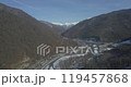 Aerial of a highway in the mountains. An automobile cable-stayed bridge over a mountain river in a gorge. The concept of civil engineering in a mountainous area. 119457868