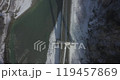 Aerial of a highway in the mountains. An automobile cable-stayed bridge over a mountain river in a gorge. The concept of civil engineering in a mountainous area. 119457869