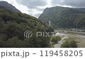 Aerial around epic modern cable-stayed bridge Adler road Krasnaya polyana Sochi Russia suburban freeway cars traffic among high mountains. Natural landscape green slopes. Travel landmark. High quality 119458205
