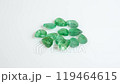 Radiant Green Gemstones Glimmering on a White Surface 119464615