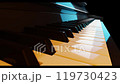 Piano keyboard in turquoise and orange light fast close-up backward panning. 119730423