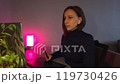 Young woman using a laptop and graphic tablet at home in the evening 119730426