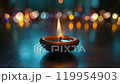 A single burning diyas. Diwali, the Hindu festival of lights. Moving flame and lights in the background 119954903