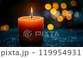 burning candle with dark bokeh background 119954931