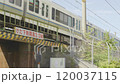 A morning commuter train crossing a steel bridge with clearance restrictions. 120037115