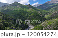 Drone flyby of a railway bridge in Corsicas dramatic mountains highlighting rugged landscape views during daytime 120054274