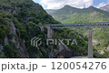 Drone flyby of a railway bridge in Corsicas dramatic mountains highlighting rugged landscape views during daytime 120054276