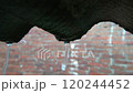 Heavy Rain Pouring Over a Corrugated Roof with Brick Wall Background 120244452