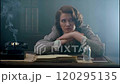 Businesswoman in her office is resting her chin on her hands, waiting impatiently for the phone to ring. She is surrounded by paperwork and a vintage rotary phone 120295135