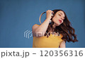 Jovial young woman dancing while listening to 120356316