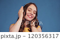 Jovial young woman dancing while listening to 120356317