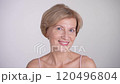 Pretty blond mature woman looking at camera and smiling. Beauty skincare and anti-aging facial care. Portrait on white background. 120496804