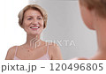 Youthful gorgeous middle-aged woman is happy while looking at her appearance. Confident modern female in love with her authenticity. Slo mo 120496805