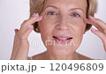Closeup portrait of a charming middle-aged female who lovingly takes care of her skin, embracing the essence of selflove and confident aging 120496809