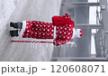 anta Claus dressed in a red robe, carrying a staff and bag, walks through a frosty industrial space. A cinematic contrast of tradition and modernity. 120608071