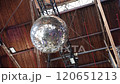Shimmering Disco Ball. A gleaming disco ball hangs from the ceiling, reflecting an array of lights 120651213
