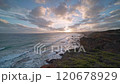 Waves breaking against volcanic rock formations at sunset on the south coast of Australia. 120678929
