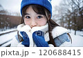 A beautiful girl is staring coldly in the snow, blinking 120688415