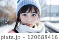 A beautiful girl is touching the screen while powder snow is falling. 120688416
