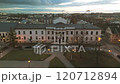 A peaceful evening scene of a city square with illuminated buildings, including a grand government building. The image captures the calm atmosphere and the beauty of the urban landscape. 120712894