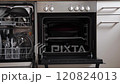 Modern kitchen with a dishwasher full of clean plates and utensils. Camera movement to the left 120824013