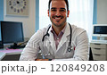 Portrait of smiling doctor sitting in medical office 120849208
