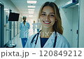 Portrait woman of young nurse confident female doctor smiling in hospital corridor 120849212