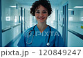 Portrait woman of young nurse confident female doctor smiling in hospital corridor 120849247