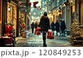 Woman walking down snowy street carrying shopping bags during christmas time 120849253