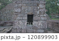 Candi Sukuh - 15th century Javanese Hindu Pyramidal temple in Central Java, Indonesia on the western slope of Mount Lawu with erotic art sculptures ruin 120899903