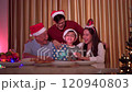 Happy cheerful Asian family is celebrating Christmas and New Year dinner party together, a family with mother, father and son. Asian lovely family celebrate Christmas - New Year festival. 120940803