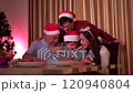 Happy cheerful Asian family is celebrating Christmas and New Year dinner party together, a family with mother, father and son. Asian lovely family celebrate Christmas - New Year festival. 120940804