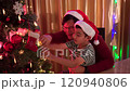 Happy cheerful Asian family celebrating Christmas and New Year dinner party together, a family with father and son. Asian lovely family celebrate Christmas - New Year festival. 120940806